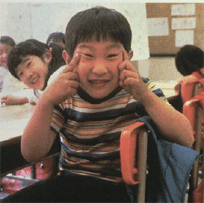 This little   Japanese boy from the USA turns a gesture of ridicule into a good-natured    acknowledgement of his heritage at his Buddhist school.